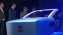 James 2025, a prototype of the interior of a future autonomous car, at the opening ceremony of 2025, watched by Stephan Weil, David Cameron, Angela Merkel and Dieter Kempf.